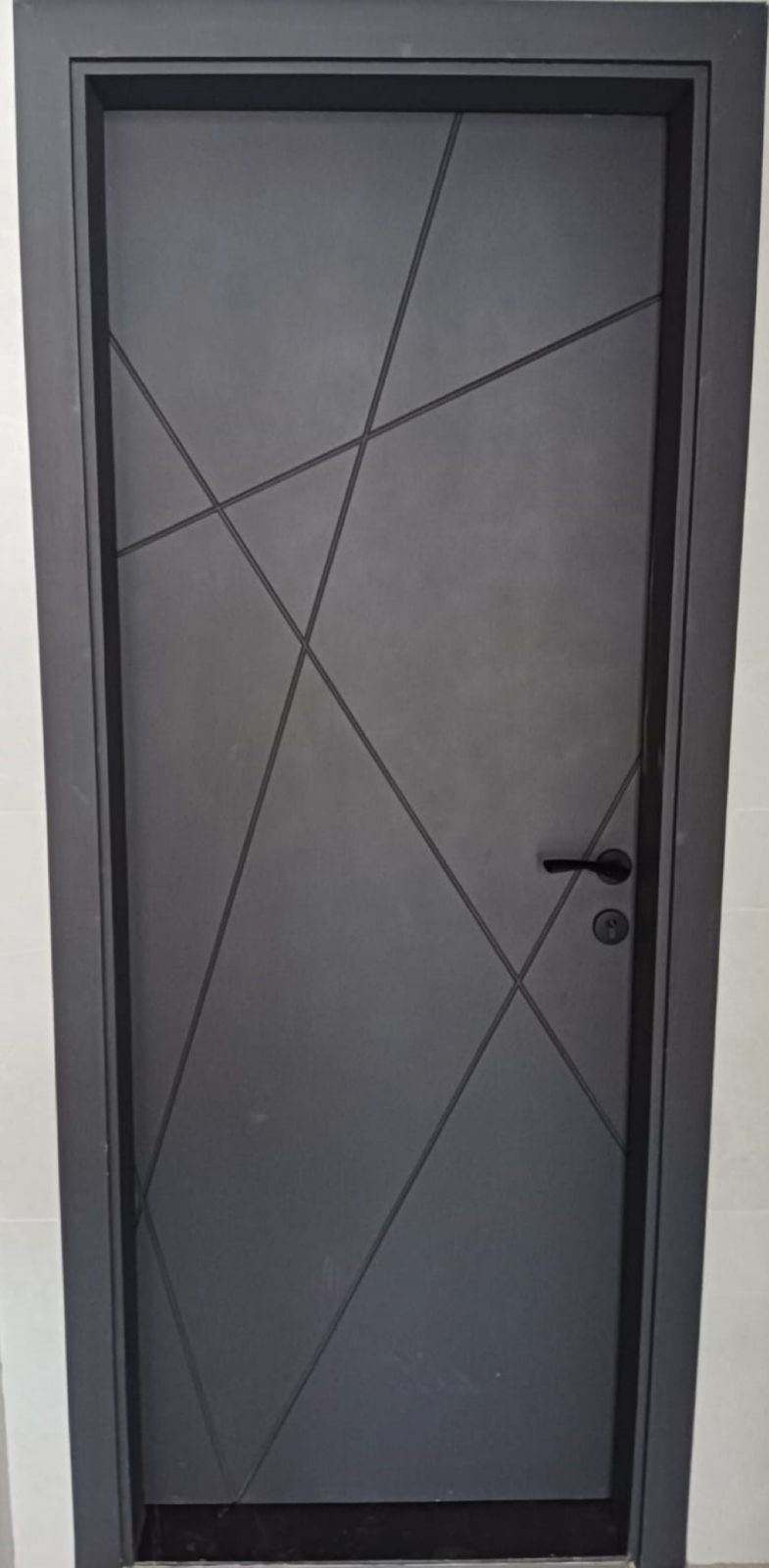 Dark geometric groove fire door installed